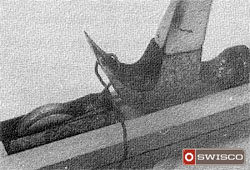 Photo of the Pella roller assembly being removed using a wire loop and a hammer.