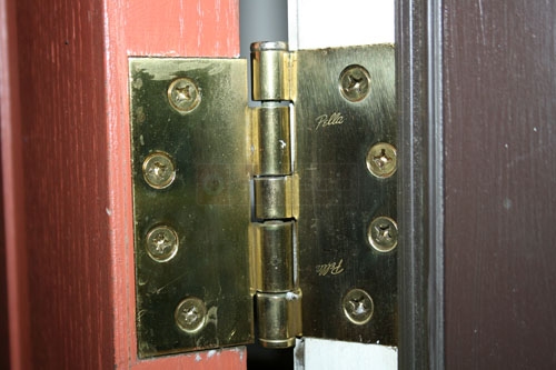 User submitted photo of their Pella wood door hinge.