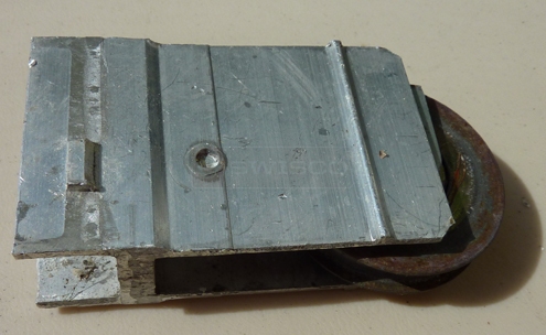 A customer submitted photo of a sliding glass door roller.