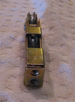 A customer submitted photo of a sliding glass door roller.