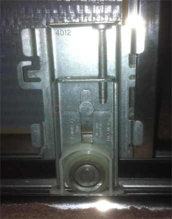 A customer submitted photo of a mirror closet door roller.