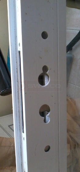 A customer submitted photo of door handle installation holes.
