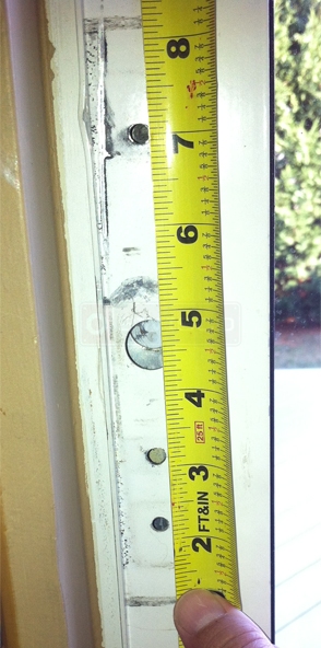 A customer submitted photo of patio door handle installtion holes.