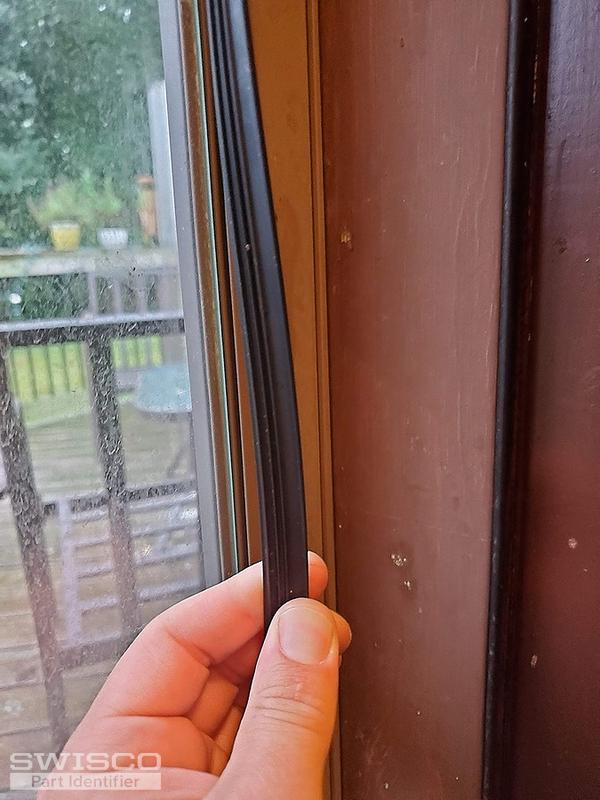 Storm door panel retainer