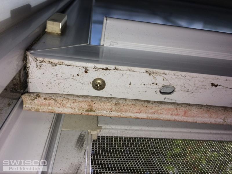 Underside of lower sash, at connection of balance,