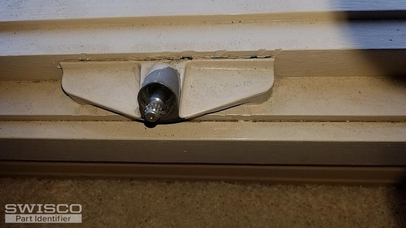Window crank holder with nutlike piece removed