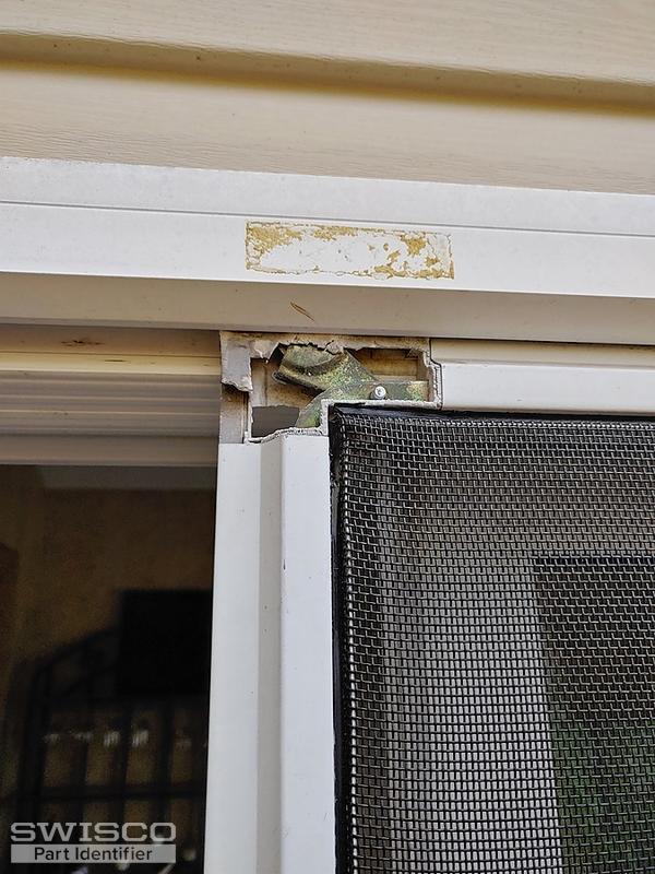 Corner slides with plastic cover on patio screen door. Plastic cover is