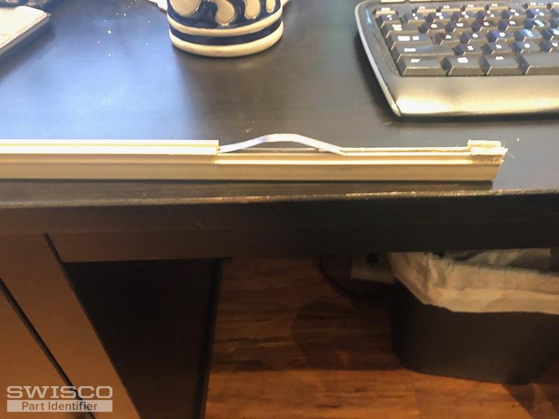 plastic track piece at bottom of door
