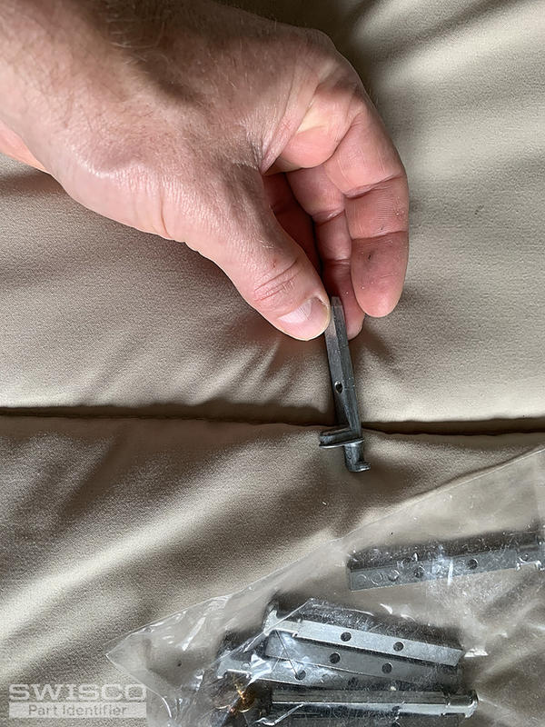 broken pin (in hand) vs replacement pins (in bag).