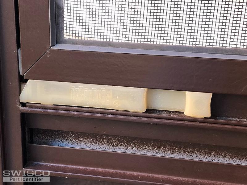 Storm door window latch