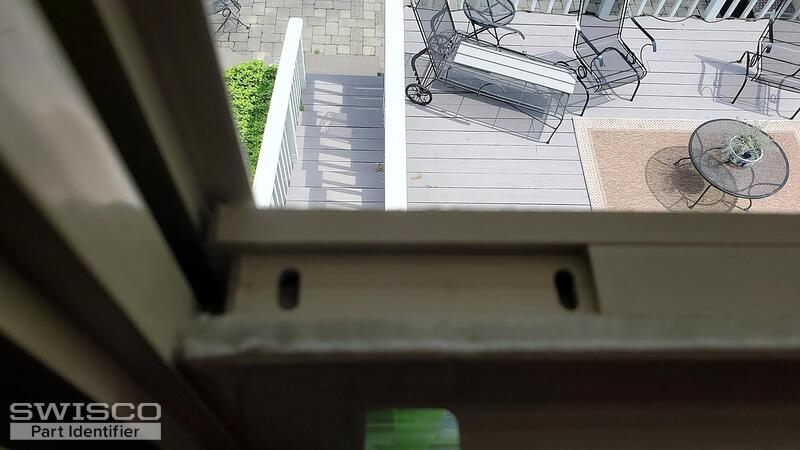 top of window frame where latch goes into 2 slots.