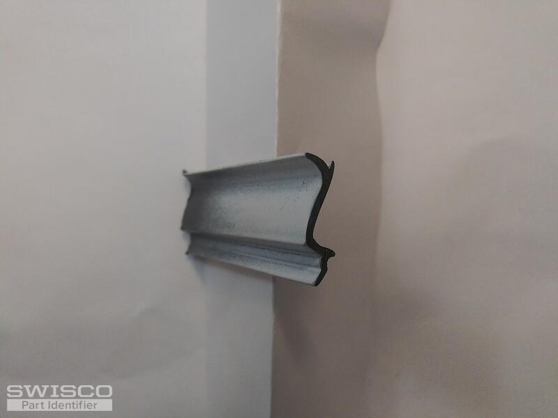 Vertical. Side abutting the glass
