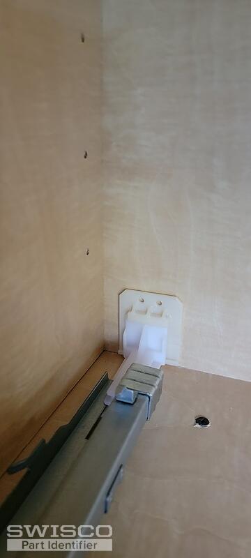 Slide attached to back of cabinet