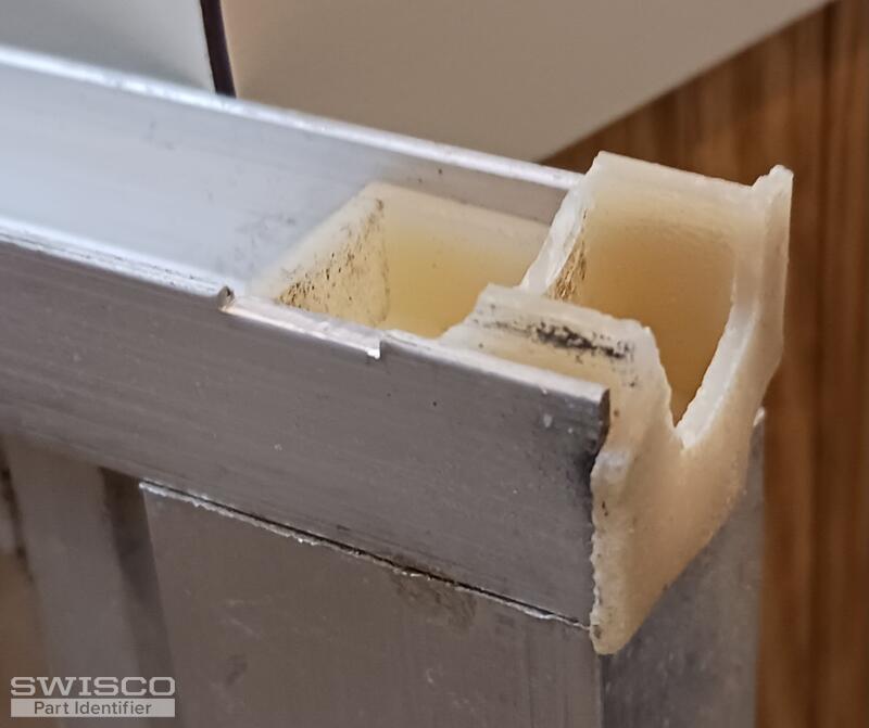 Top sash guide showing damaged top