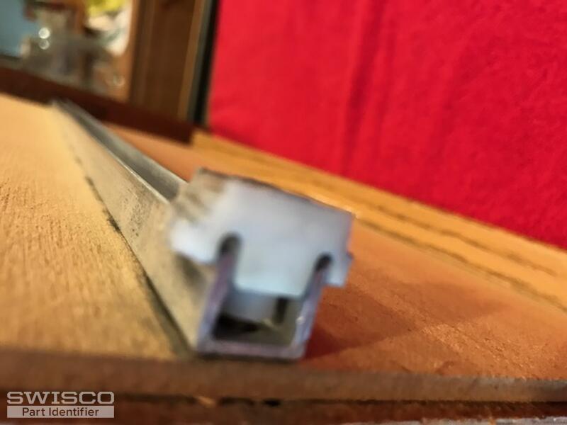 piece mounted on back, bottom of drawer 